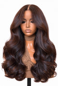 Muse raw Vietnamese wig in dark brown with subtle highlights, soft face-framing layers and bouncy curls, shown on a mannequin.